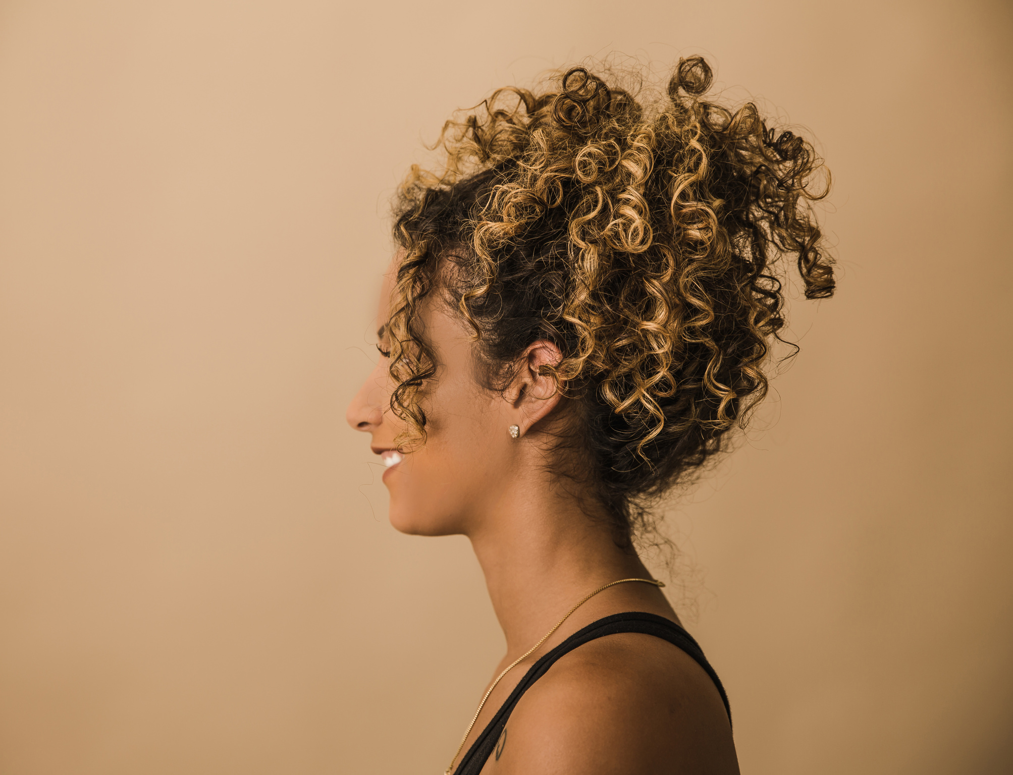 Side Profile of Woman with Curly Hair in Pony Tail 